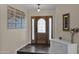 Bright entryway with wood door, tile flooring, and decorative wall art at 15429 E Palomino Blvd, Fountain Hills, AZ 85268