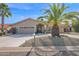 Tan one-story house with a tile roof, two-car garage, and landscaped front yard at 15429 E Palomino Blvd, Fountain Hills, AZ 85268