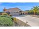 Tan one-story house with a tile roof, two-car garage, and desert landscaping at 15429 E Palomino Blvd, Fountain Hills, AZ 85268