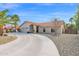 Tan one-story house with tile roof and curved driveway at 15429 E Palomino Blvd, Fountain Hills, AZ 85268