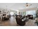 Spacious living room with leather sofas, wood flooring, and fireplace at 15429 E Palomino Blvd, Fountain Hills, AZ 85268