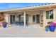 Covered patio with dining set and colorful flower pots at 15429 E Palomino Blvd, Fountain Hills, AZ 85268