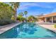 Refreshing pool surrounded by palm trees and a spacious patio at 15429 E Palomino Blvd, Fountain Hills, AZ 85268