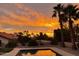 Dramatic sunset view from a backyard pool area at 15429 E Palomino Blvd, Fountain Hills, AZ 85268