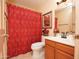 Bright bathroom with wood vanity and red accents at 15435 N 51St St, Scottsdale, AZ 85254