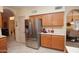 Kitchen features stainless steel refrigerator and oak cabinets at 15435 N 51St St, Scottsdale, AZ 85254