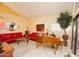 Bright living room with red couches and large window at 15435 N 51St St, Scottsdale, AZ 85254