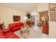 Living room featuring red couches and a grand piano at 15435 N 51St St, Scottsdale, AZ 85254