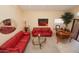 Relaxing living room with red leather couches and a piano at 15435 N 51St St, Scottsdale, AZ 85254