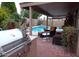 Inviting pool area with patio furniture and grill at 15435 N 51St St, Scottsdale, AZ 85254