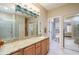 Bathroom with granite vanity, large mirror, and shower at 15725 W Linksview Dr, Surprise, AZ 85374