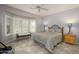 Bright bedroom with a queen-size bed and bay window at 15725 W Linksview Dr, Surprise, AZ 85374