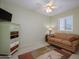 Cozy bedroom with a sofa, dresser, and plenty of natural light at 15725 W Linksview Dr, Surprise, AZ 85374