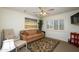 Serene bedroom with comfortable seating and large window at 15725 W Linksview Dr, Surprise, AZ 85374