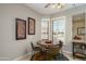 Charming breakfast nook with wood table and chairs, near a window at 15725 W Linksview Dr, Surprise, AZ 85374