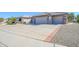 Two-car garage with a long driveway and desert landscaping at 15725 W Linksview Dr, Surprise, AZ 85374