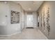 Bright and airy entryway with tile flooring and decorative wall art at 15725 W Linksview Dr, Surprise, AZ 85374