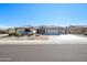 House exterior with desert landscaping and a three-car garage at 15725 W Linksview Dr, Surprise, AZ 85374