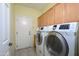 Convenient laundry room with washer, dryer, and extra storage at 15725 W Linksview Dr, Surprise, AZ 85374