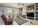 Relaxing living room with a fireplace and plenty of natural light at 15725 W Linksview Dr, Surprise, AZ 85374