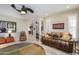 Open living room with leather couches and a view into the kitchen at 15725 W Linksview Dr, Surprise, AZ 85374