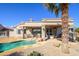 Relaxing pool area with patio furniture and a palm tree at 15725 W Linksview Dr, Surprise, AZ 85374