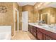 Elegant bathroom with double vanity and a relaxing soaking tub at 15839 W Calavar Rd, Surprise, AZ 85379