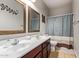 Clean bathroom with double sinks and shower/tub combo at 15839 W Calavar Rd, Surprise, AZ 85379