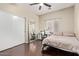 Well-lit bedroom with full-length mirror and home office setup at 15839 W Calavar Rd, Surprise, AZ 85379