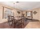 Dining area with a dark wood table and chairs, hardwood floors, and natural light at 15839 W Calavar Rd, Surprise, AZ 85379