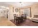 Bright dining room features a table with four chairs and hardwood floors at 15839 W Calavar Rd, Surprise, AZ 85379