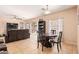 Open concept dining area with table and chairs, adjacent to living room at 15839 W Calavar Rd, Surprise, AZ 85379