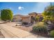 House exterior showcasing a two-car garage and well-manicured front yard at 15839 W Calavar Rd, Surprise, AZ 85379