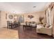 Living room features dark hardwood floors, a neutral color palette, and ample natural light at 15839 W Calavar Rd, Surprise, AZ 85379