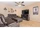 Relaxing living room with leather sectional sofa and electric fireplace at 15839 W Calavar Rd, Surprise, AZ 85379