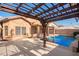 Refreshing swimming pool with pergola and backyard access at 15839 W Calavar Rd, Surprise, AZ 85379