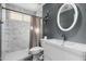 Modern bathroom featuring a walk-in shower, updated vanity, and stylish round mirror at 16241 S 40Th Way, Phoenix, AZ 85048