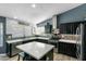 Beautiful kitchen featuring dark wood cabinets, an island with seating, stainless appliances, and stylish backsplash at 16241 S 40Th Way, Phoenix, AZ 85048