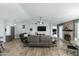 Spacious living room featuring wood floors, vaulted ceilings, a ceiling fan, and a stone fireplace at 16241 S 40Th Way, Phoenix, AZ 85048