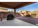 Backyard has covered patio, grill and gravel landscaping at 17584 W Andora St, Surprise, AZ 85388