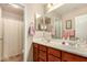 Bathroom with double sinks, a shower, and plenty of cabinet space at 17584 W Andora St, Surprise, AZ 85388