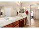 Double vanity bathroom with ample storage and a view into the bedroom at 17584 W Andora St, Surprise, AZ 85388