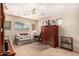 Relaxing bedroom with a sofa, wooden armoire and neutral color scheme at 17584 W Andora St, Surprise, AZ 85388