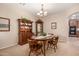 Formal dining room featuring a wood table and chairs, hutch and display cabinet at 17584 W Andora St, Surprise, AZ 85388