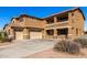 Two-story house with a three-car garage and a large driveway at 17584 W Andora St, Surprise, AZ 85388