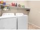 Laundry room with washer, dryer and shelving at 17584 W Andora St, Surprise, AZ 85388