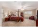 Spacious main bedroom with a post bed, ample dresser space, and calming decor at 17584 W Andora St, Surprise, AZ 85388