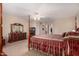 Main bedroom with a post bed, dresser, and ensuite bathroom access at 17584 W Andora St, Surprise, AZ 85388