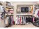 Large walk-in closet with custom shelving and hanging rods at 17584 W Andora St, Surprise, AZ 85388