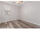 Simple bedroom with wood-look floors and window at 17962 W Vogel Ave, Waddell, AZ 85355